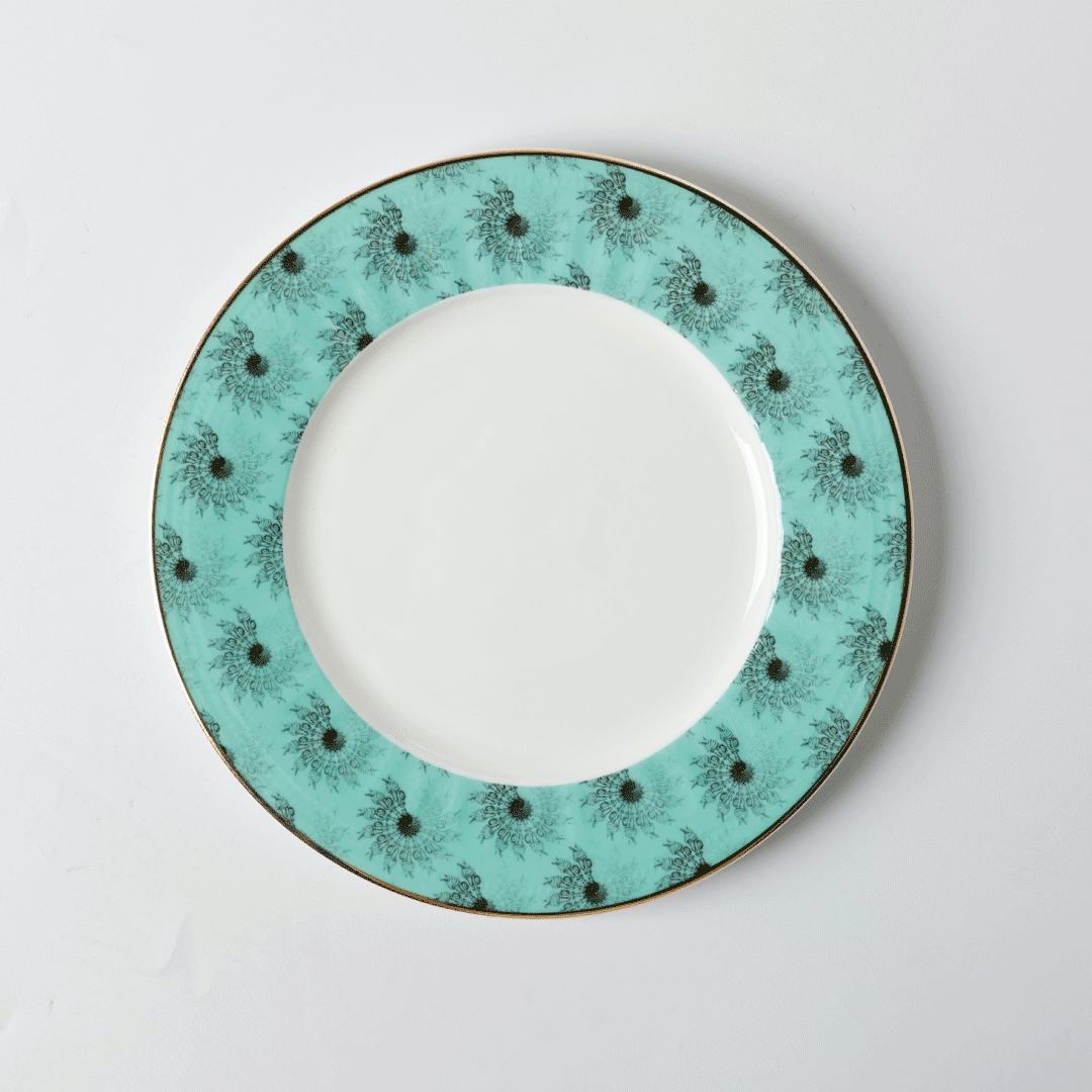 Turquoise and white porcelain plate with black pattern and Babingtons' logo